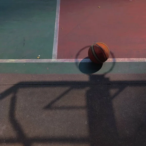 basketball court with ball on the ground