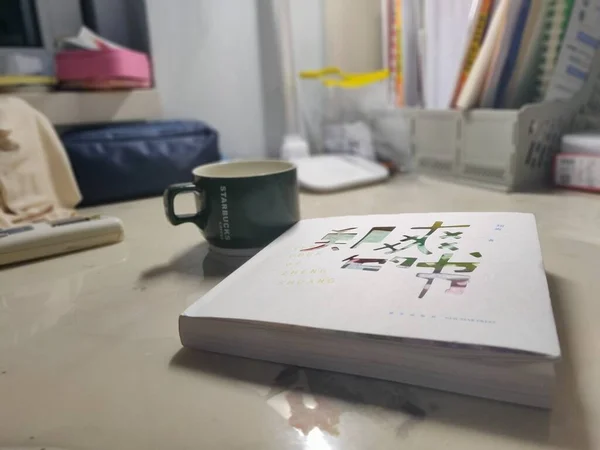a cup of coffee and a book on the table