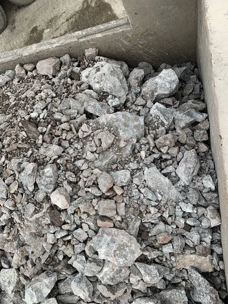 concrete floor with a large pile of stones