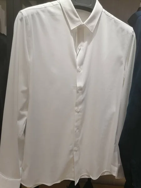 white shirt with a hanger on a mannequin