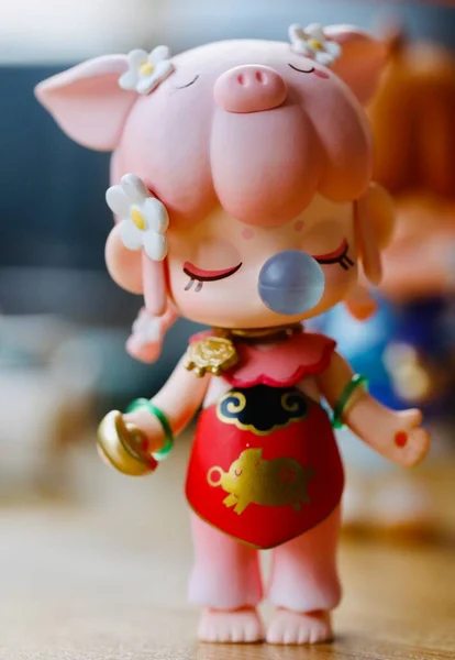 a closeup shot of a cute doll with a toy figurine