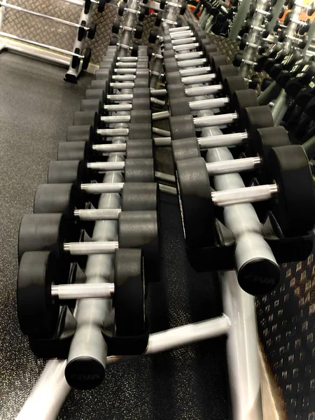 empty gym hall with dumbbells