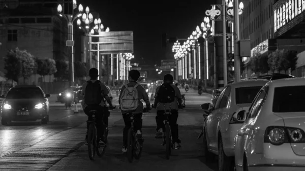 black and white photo of a street in the city