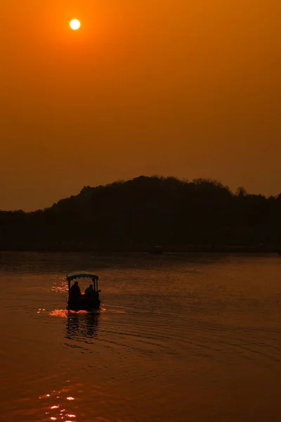 silhouette of a man on the lake