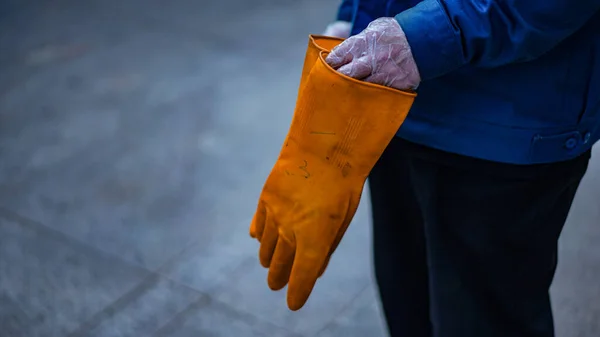 man in a protective gloves is holding a bag of water.