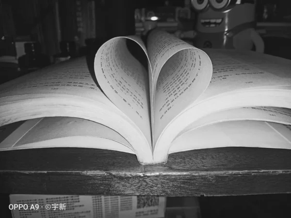 a book with a heart and a white background