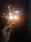 sparkler in the hands of a woman hand