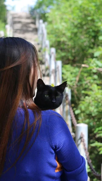 young woman with cat in the park