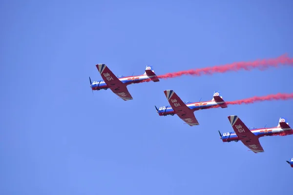 red and white planes flying in the sky
