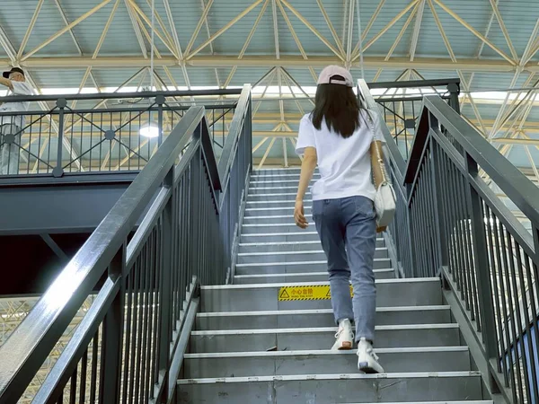 young man with backpack walking on the stairs