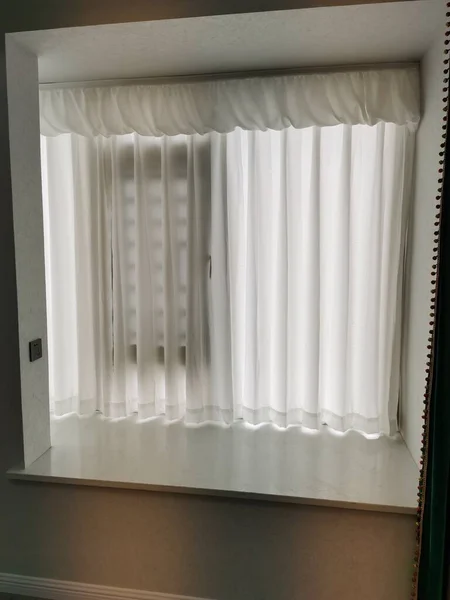 white curtains on the window