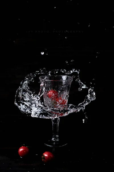 red apple with water splash on black background