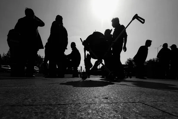 black and white image of a group of people in the park