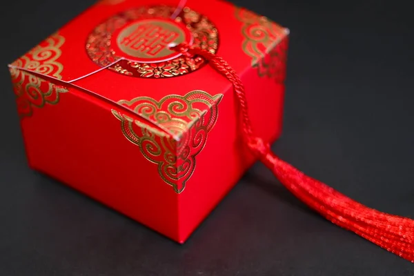 red envelope with a gift box on a black background