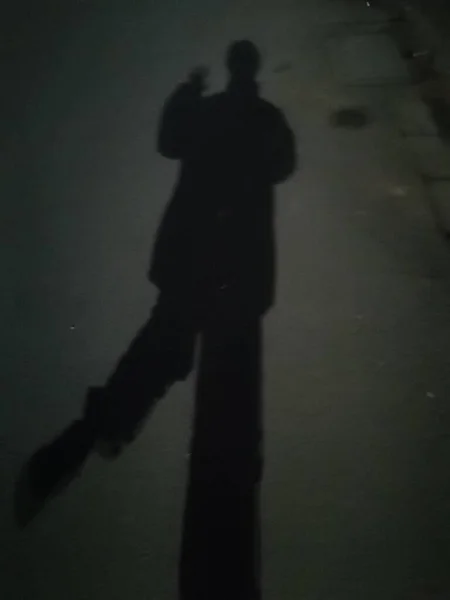 silhouette of a man in a black suit