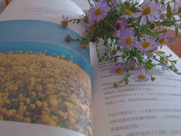 a beautiful bouquet of flowers and a book