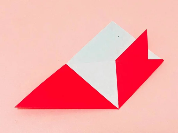 paper origami envelope on pink background