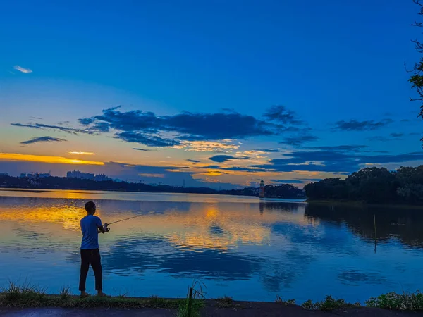 silhouette of a man on the lake