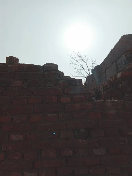 old brick wall with a large window