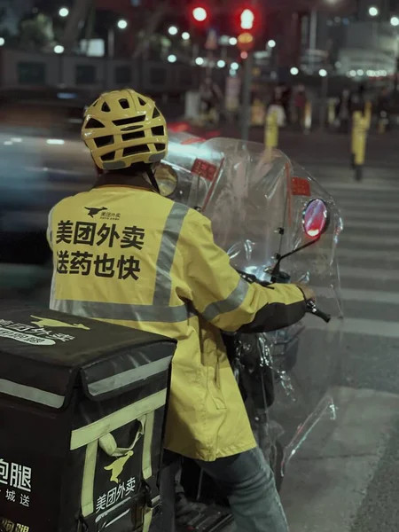 street photo of a man in a protective mask and a helmet with a lot of lights