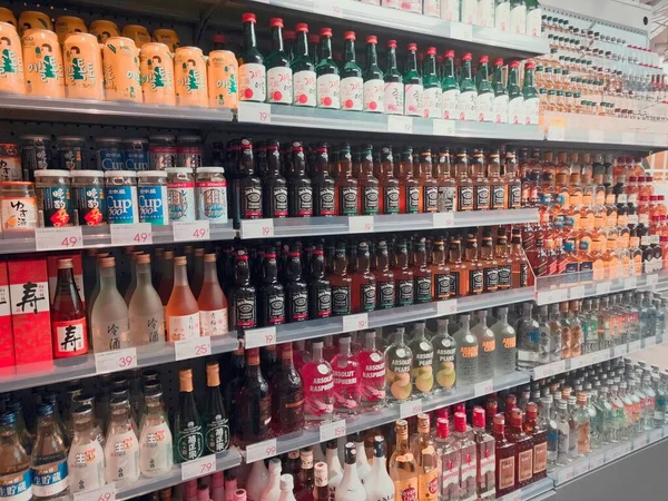 pharmacy store shelves with bottles of wine and other products