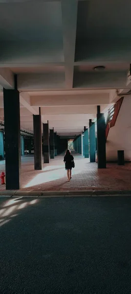 silhouette of a man in a black suit and a white shirt on the street