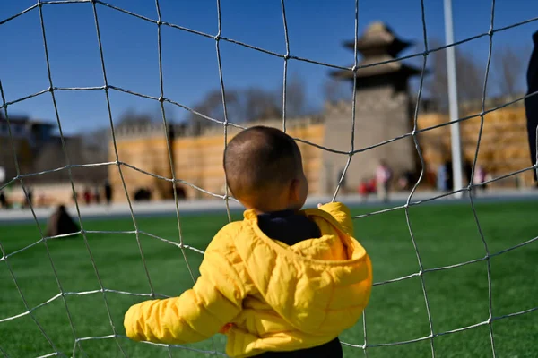 cute little boy with a ball in the park