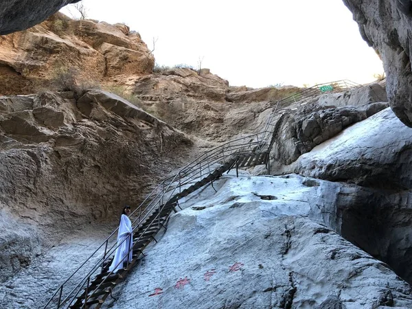 the man is climbing the stairs in the mountains