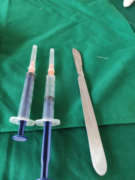 syringe with a needle and a stethoscope