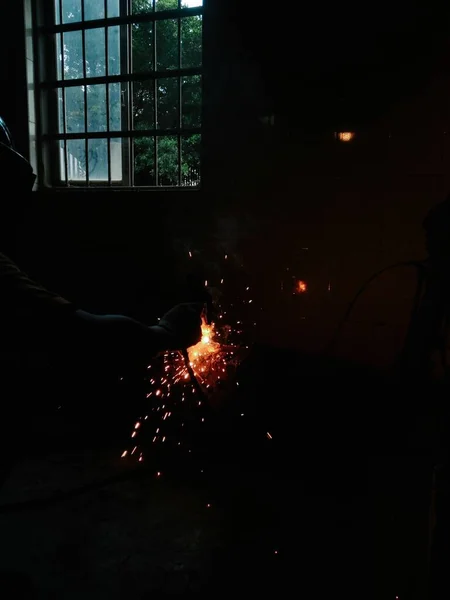 sparks welding metal with a fire