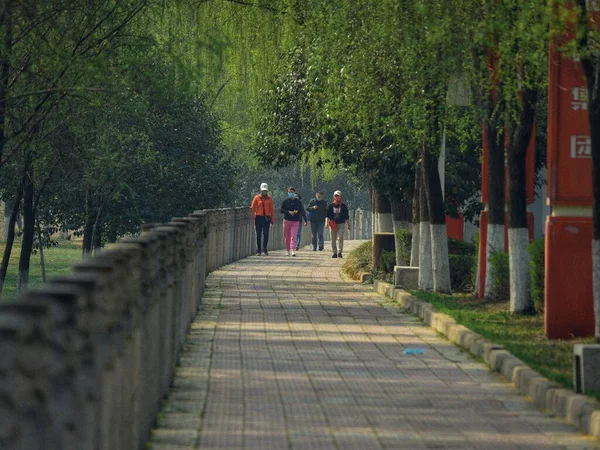 a man walking along the path in the park