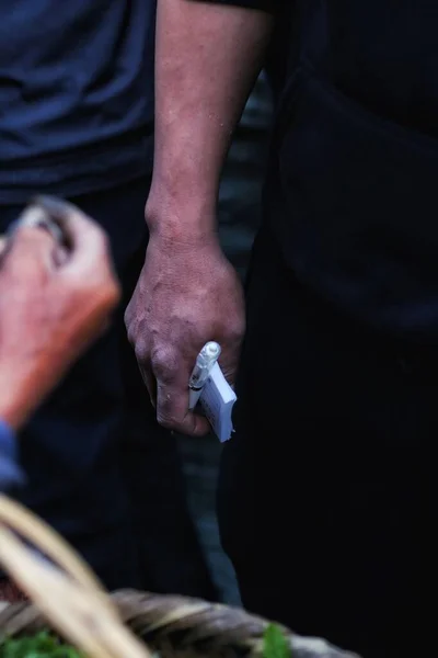 man\'s hands with a tattoo on the background of the old building