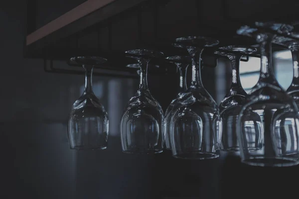 empty glass bottles with white wine on black background