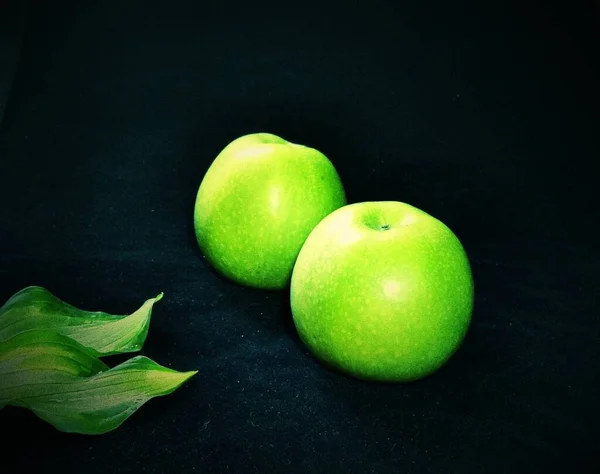 green apple on black background