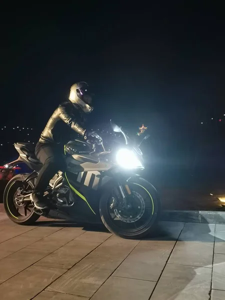 black motorcycle rider on a dark background