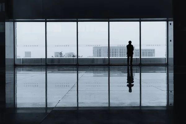 silhouette of a businessman in a modern office interior