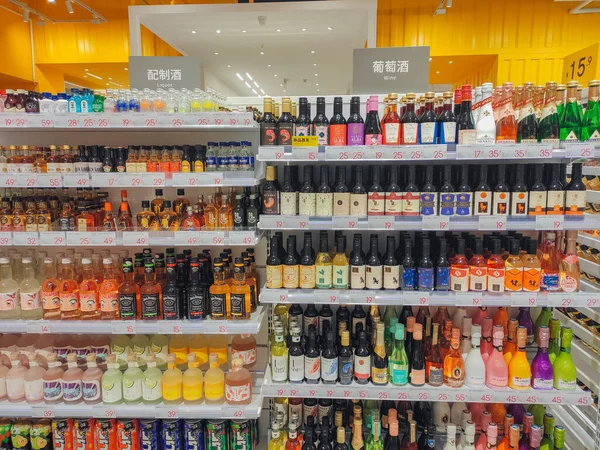supermarket shelves with bottles of wine in the store