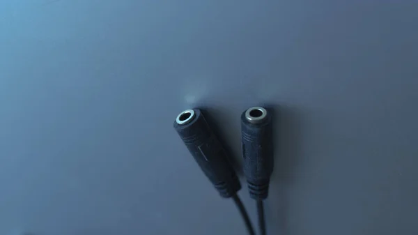 black electric plug on a blue background