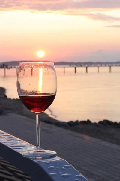 wine glasses on the beach at sunset