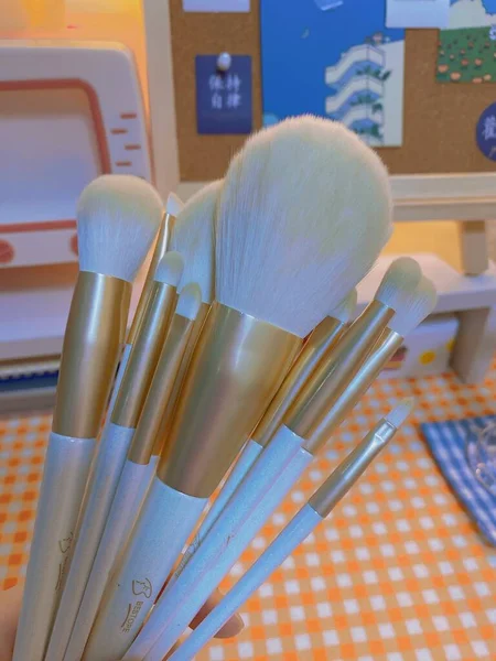 set of makeup brushes and brush on a white background