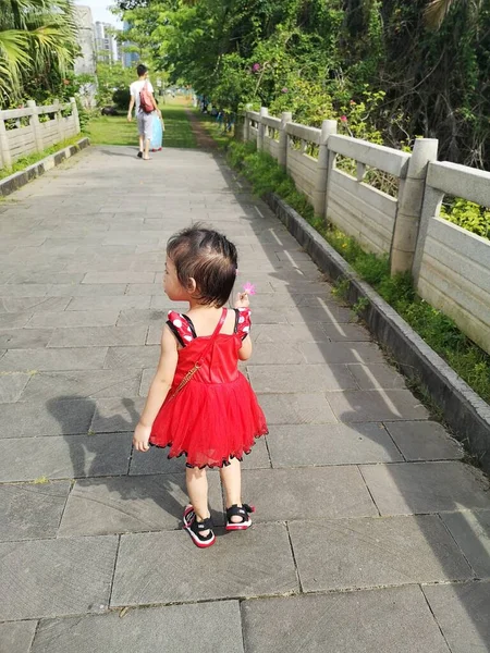 stock image little girl with her daughter walking in the park