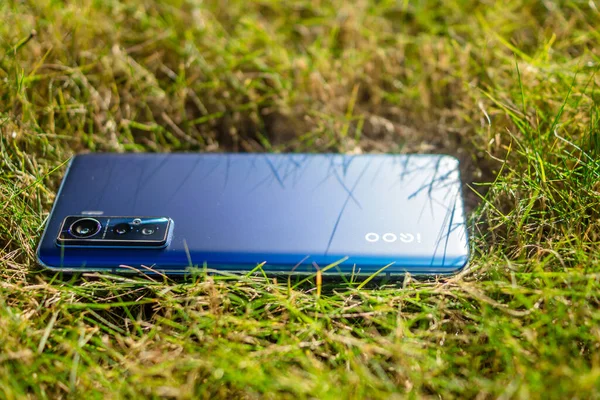 mobile phone with a blank screen on the grass