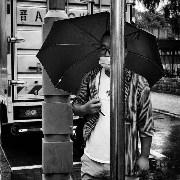 young man with umbrella in the city
