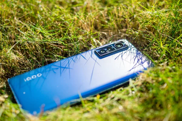 mobile phone with a smartphone on the grass