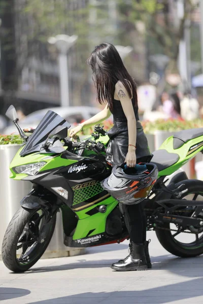 young woman riding a motorcycle