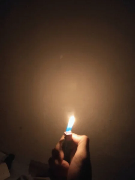 burning candle in hand