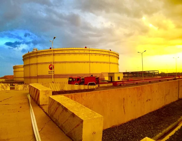 industrial factory, barrel, tank, sky, clouds, water, oil, storage,