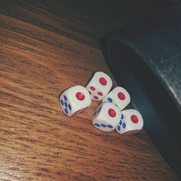 dice and dices on a wooden table