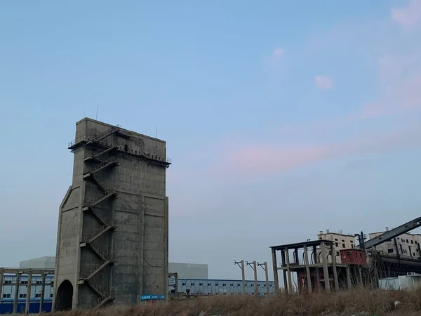 industrial factory, concrete building, construction site, abandoned buildings, blue sky, clouds, smoke,