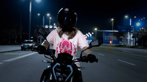 young woman with motorcycle helmet on the street